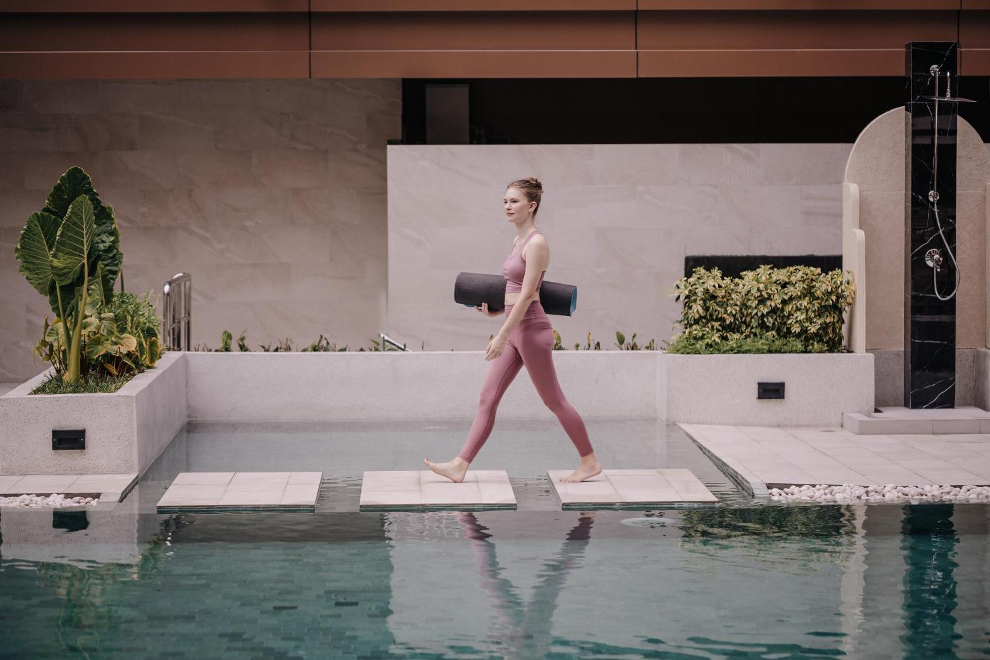 Nysa Hotel Bangkok Sukhumvit 11 Exterior photo A woman walking on a stepping stone